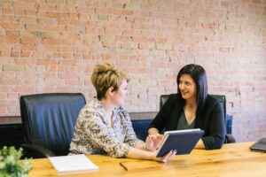 A marketing advisor and a business owner talking through a plan together at a conference table