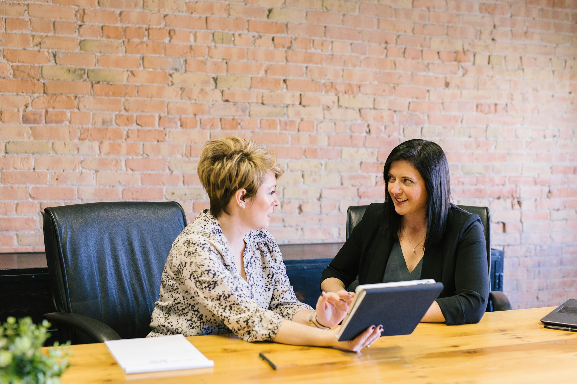 A marketing advisor and a business owner talking through a plan together at a conference table